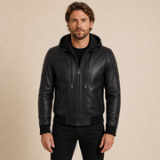 Man wearing a MOTOGRIP GEAR black quilted-shoulder hooded lambskin bomber jacket, front view.