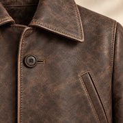 Close view of distressed brown Napa leather, collar and leather-covered button