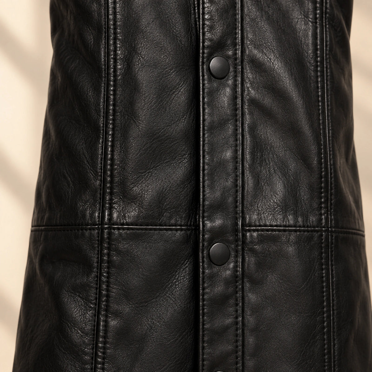 Close view of the Nightwarden trench vertical panel seams and snaps