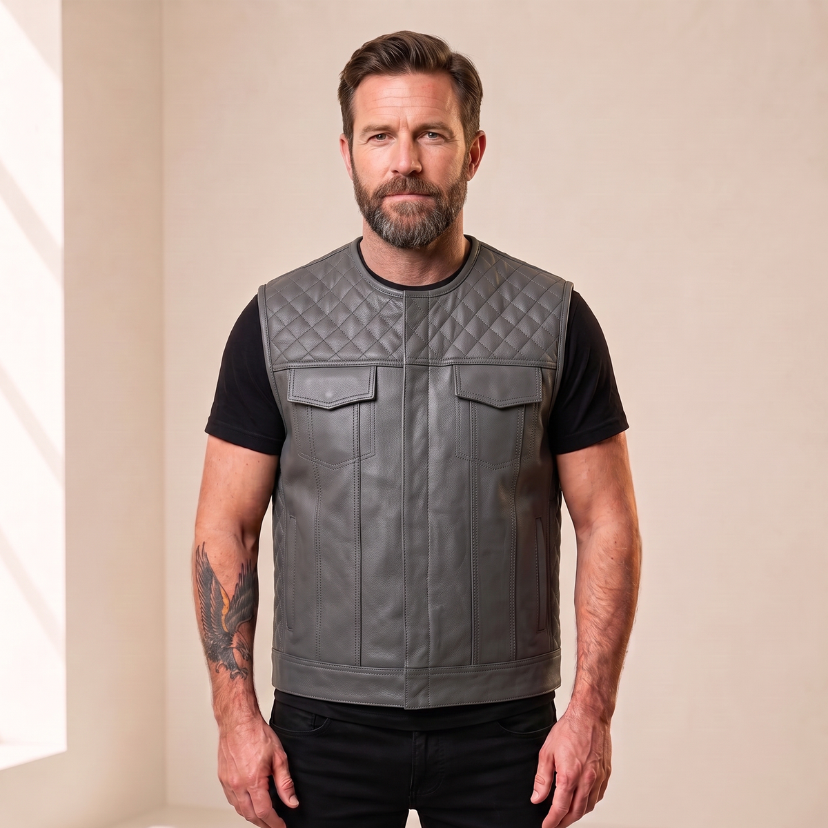 Man wearing the men's gray diamond-quilted cowhide leather motorcycle vest, front view