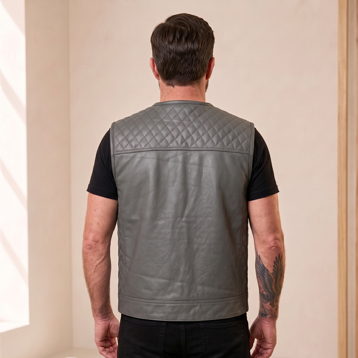 Man wearing the men's gray cowhide leather motorcycle vest, back view