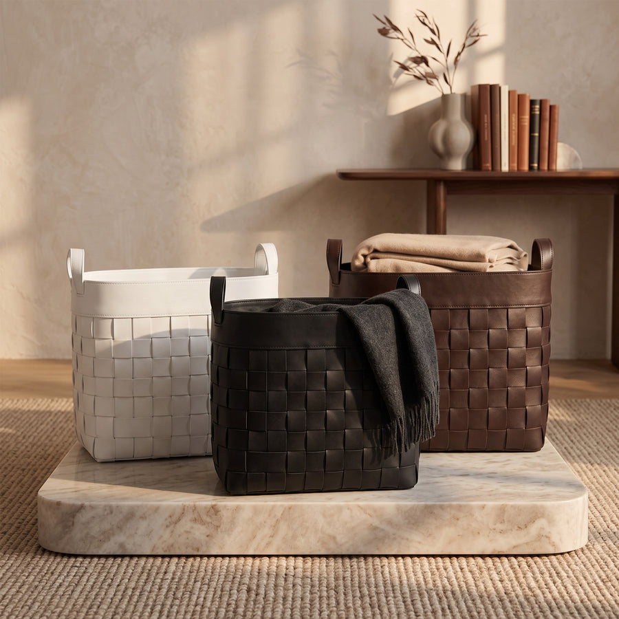 Black, brown and white woven genuine leather storage baskets styled with blankets