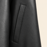 Black men's point-collar lambskin leather jacket, pocket detail.