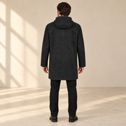 Rear view worn by a male model of the Bexley men's black hooded reversible leather coat.
