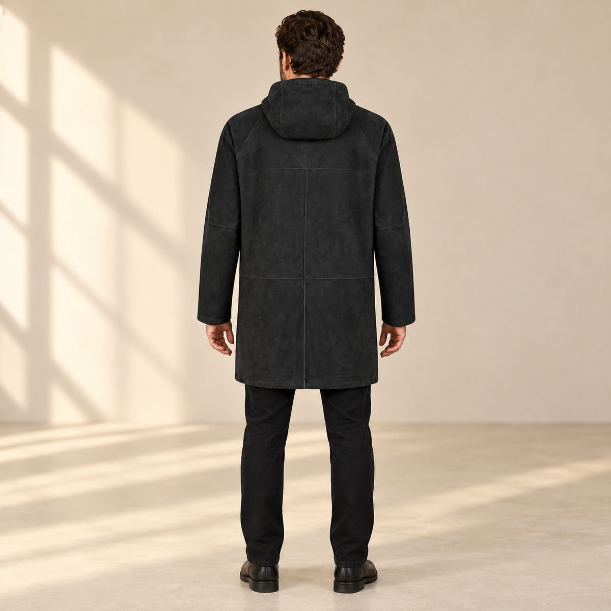 Rear view worn by a male model of the Bexley men's black hooded reversible leather coat.