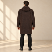 Rear view worn by a male model of the Bexley men's dark brown hooded reversible leather coat.