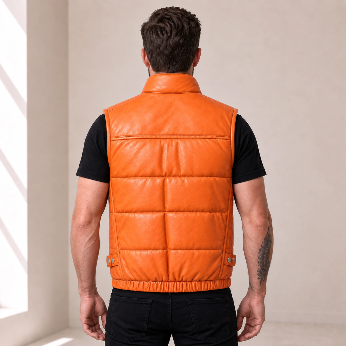 Braywick men's orange genuine leather bubble puffer vest, modeled back view