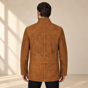 Rear view worn by a male model of the Cairnwell men's brown blue reversible leather blazer coat.
