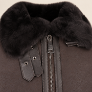 Close-up of the leather texture and construction of the Dalesmere men's dark brown shearling aviator jacket.