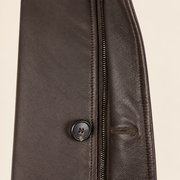 Close-up of the leather texture and construction of the Eversham men's dark brown mid-length leather coat.