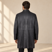 Rear view worn by a male model of the Eversham men's dark brown mid-length leather coat.