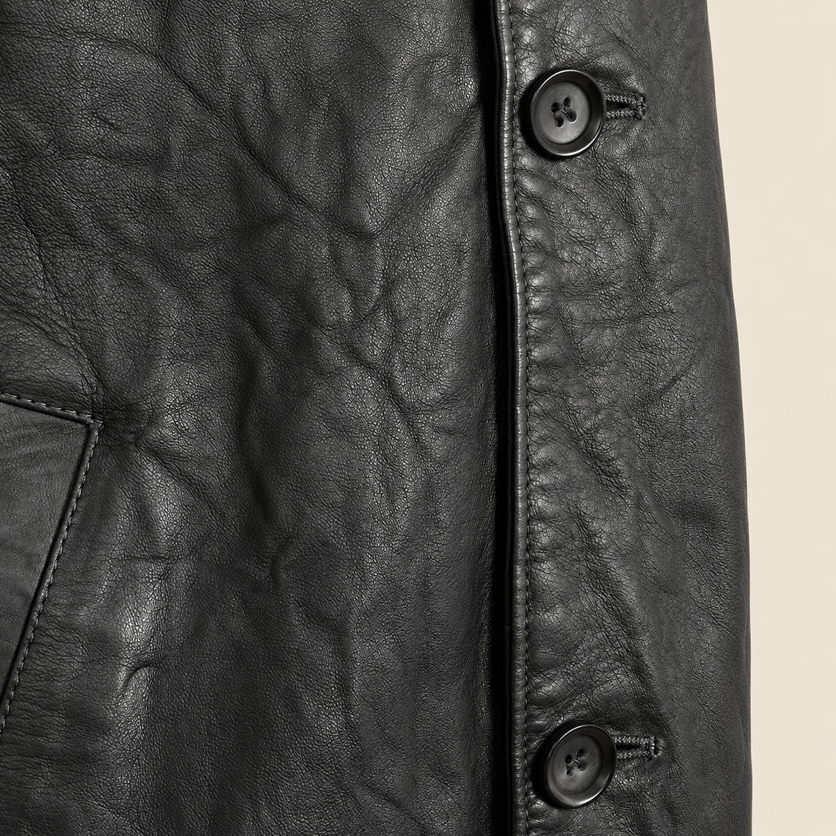 Close-up of the leather texture and construction of the Falkner men's black retro leather coat.
