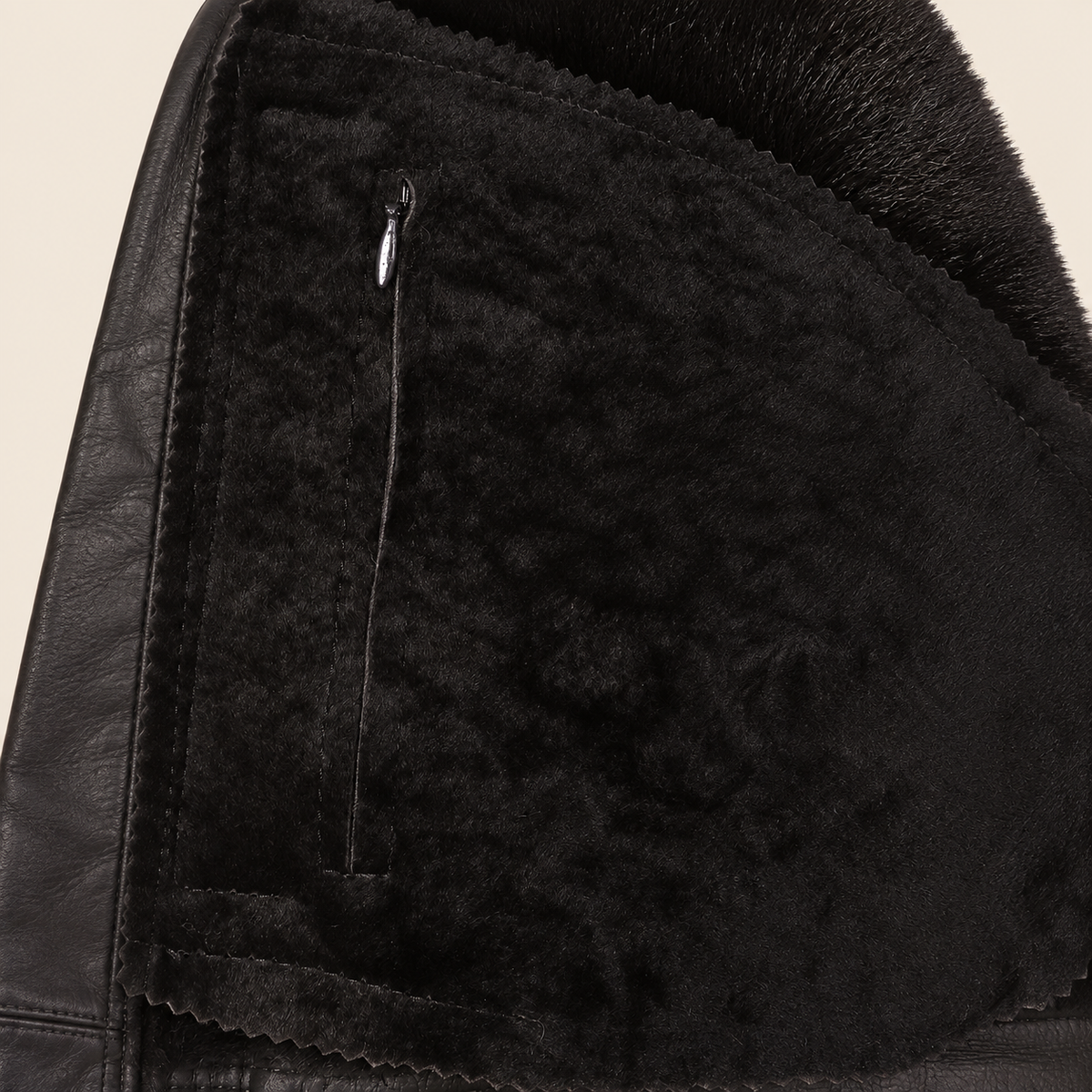 Interior construction and pocket detail of the Glenwick men's black shearling bomber jacket.