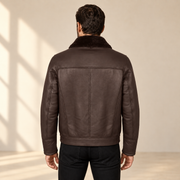 Rear view worn by a male model of the Glenwick men's brown shearling bomber jacket.
