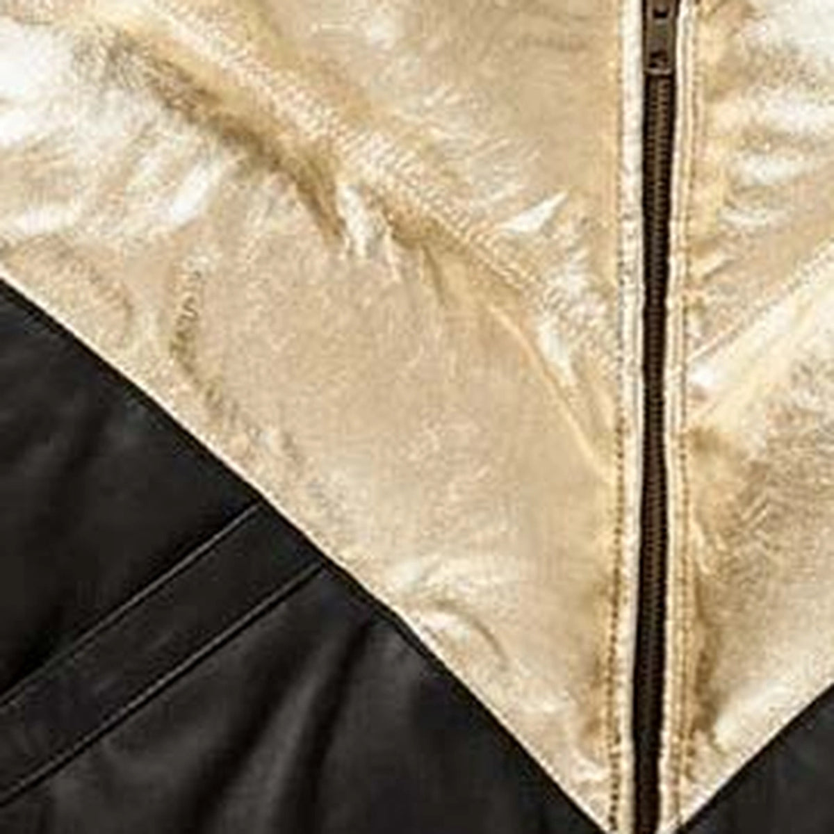 Close-up of leather texture of the MOTOGRIP black and gold lambskin leather puffer jacket, showing its black body with gold V panels.