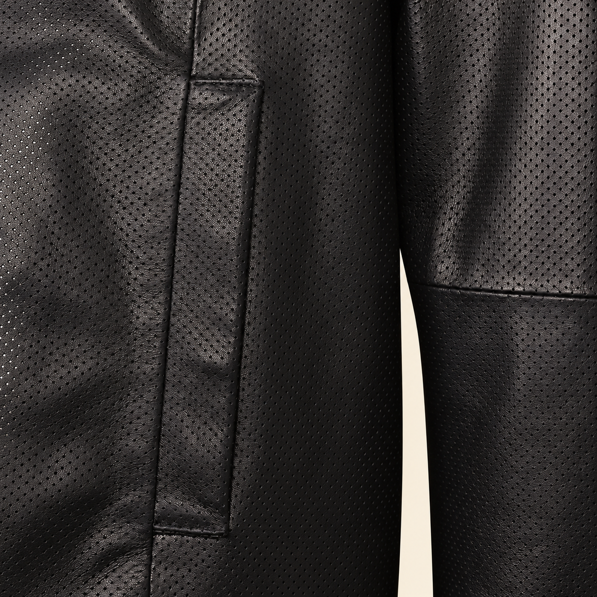Close-up of the black perforated lambskin and vertical welt pocket stitching.