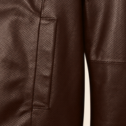 Close-up of the chocolate brown perforated lambskin and vertical welt pocket stitching.
