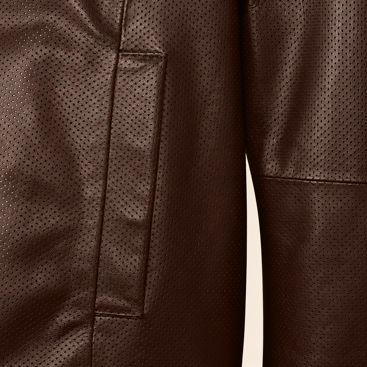 Close-up of the chocolate brown perforated lambskin and vertical welt pocket stitching.