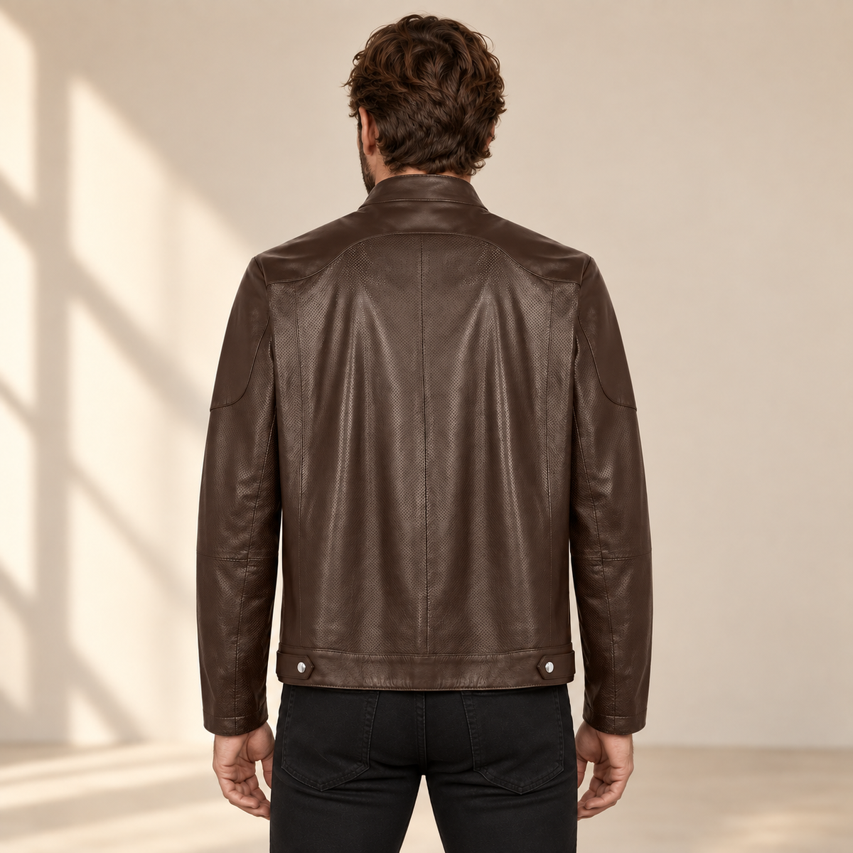 Rear model view of the Halden chocolate brown jacket showing the curved yoke, center seam and hem tabs.