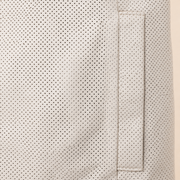 Close-up of the ivory perforated lambskin and vertical welt pocket stitching.