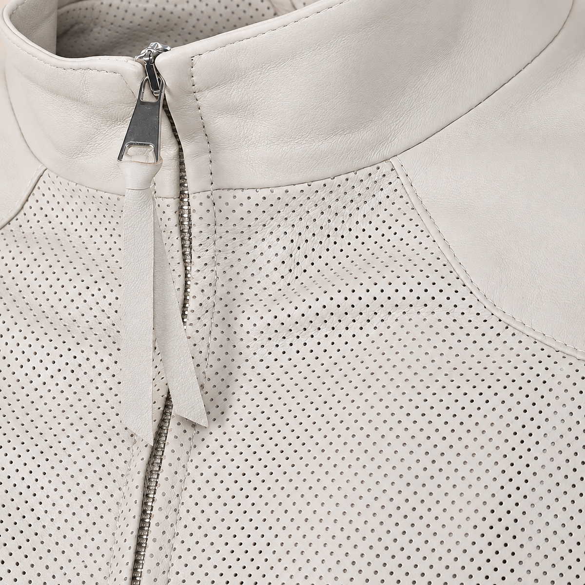 Close-up of the ivory stand collar, silver zipper and long leather zip pull.