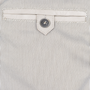 Ivory leather button-tab inner pocket against fine striped jacket lining.