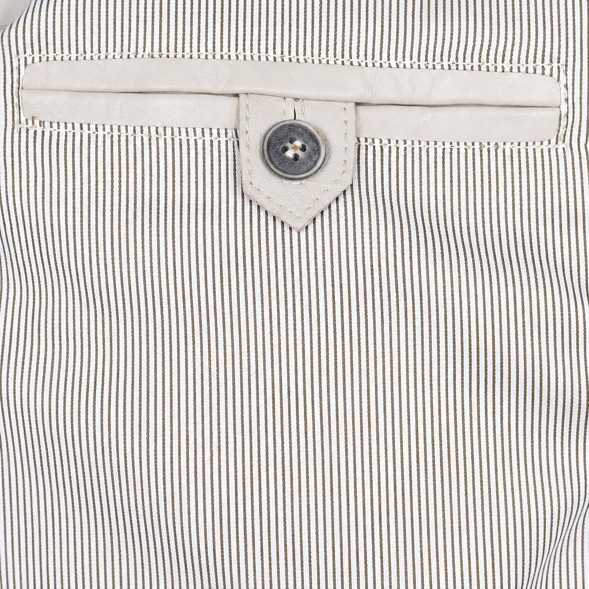 Ivory leather button-tab inner pocket against fine striped jacket lining.