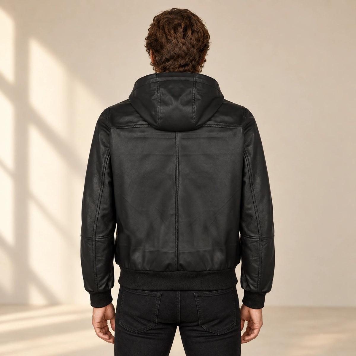 Halston Men's Hooded Lambskin Leather Bomber Jacket in black back view on male model
