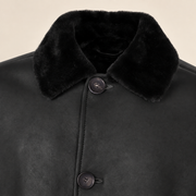 Close-up of the leather texture and construction of the Hawkridge men's black shearling car coat.