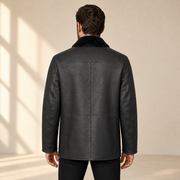 Rear view worn by a male model of the Hawkridge men's black shearling car coat.