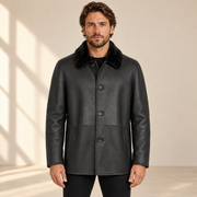 Front view worn by a male model of the Hawkridge men's black shearling car coat.