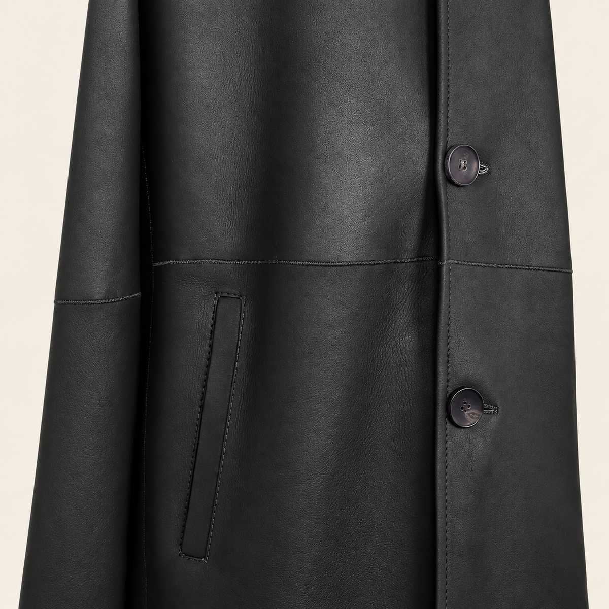 Close-up of the pocket construction of the Hawkridge men's black shearling car coat.