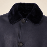 Close-up of the leather texture and construction of the Hawkridge men's navy shearling car coat.