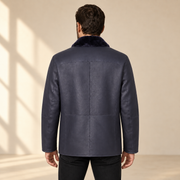 Rear view worn by a male model of the Hawkridge men's navy shearling car coat.