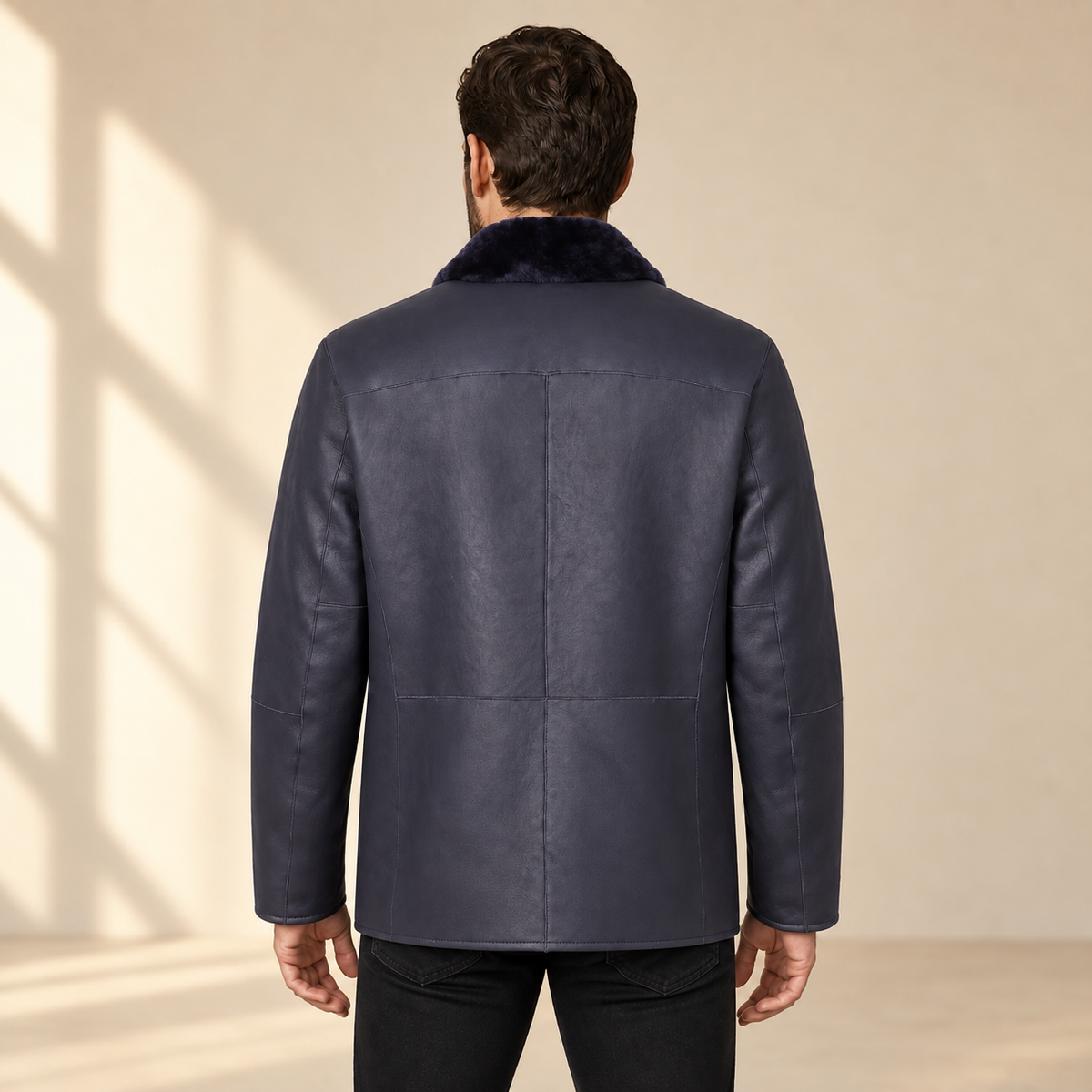 Rear view worn by a male model of the Hawkridge men's navy shearling car coat.