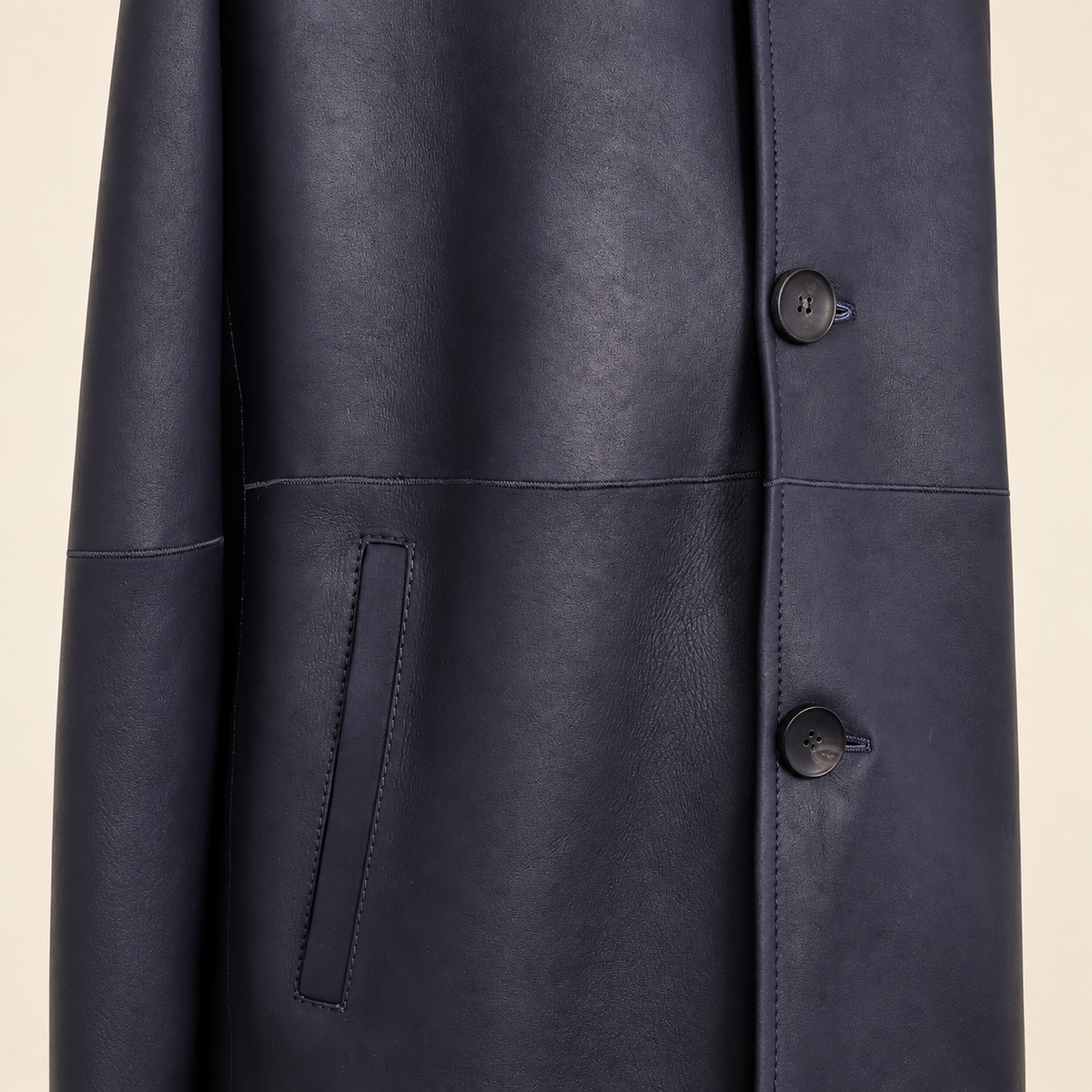 Close-up of the pocket construction of the Hawkridge men's navy shearling car coat.