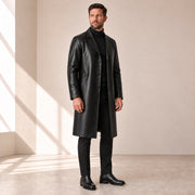 Idris men's black long leather coat, left three-quarter view on model