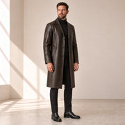 Idris men's chocolate brown long leather coat, left three-quarter view on model