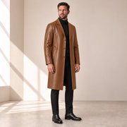 Idris men's tan long leather coat, left three-quarter view on model