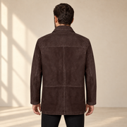 Rear view worn by a male model of the Kelston men's brown reversible suede coat.