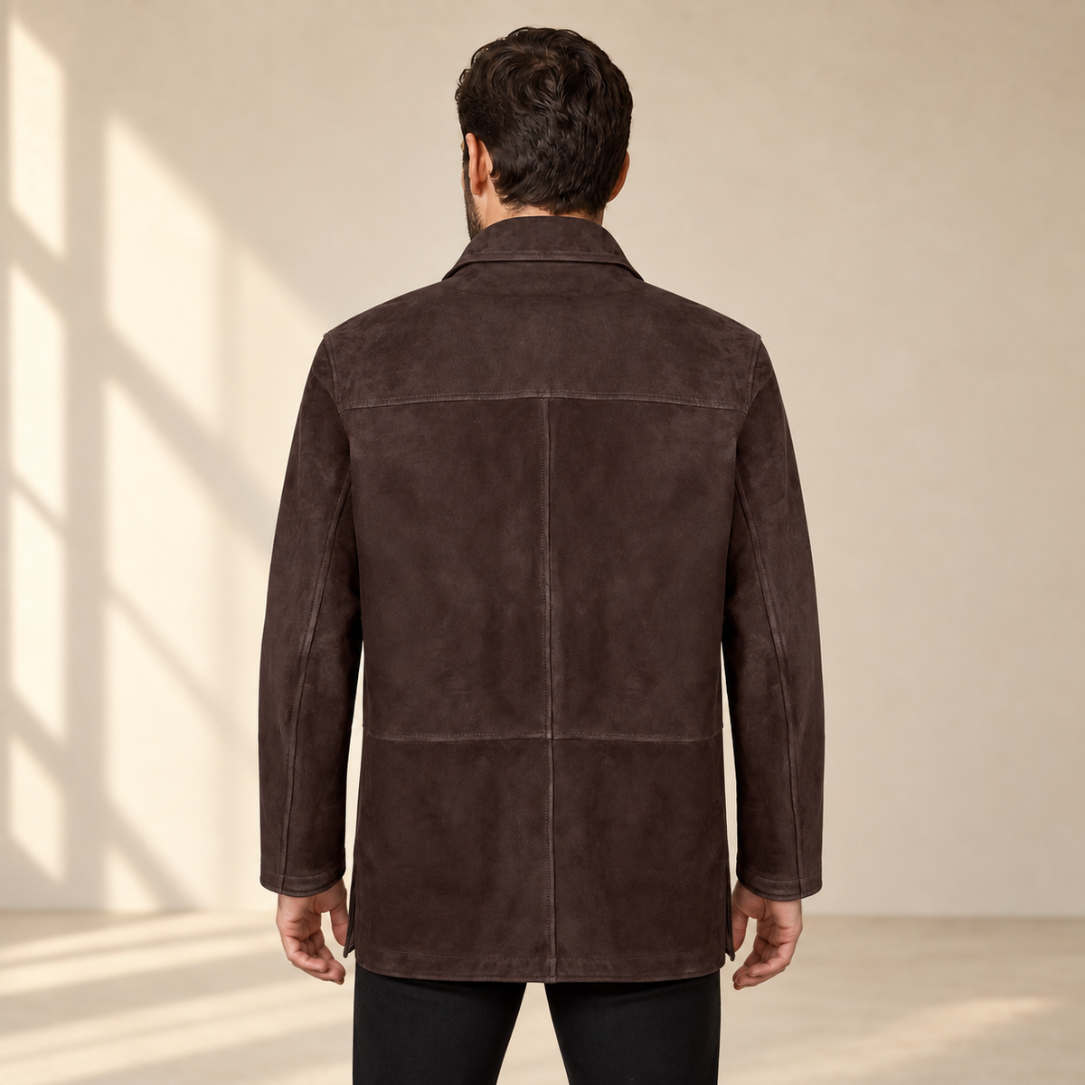 Rear view worn by a male model of the Kelston men's brown reversible suede coat.