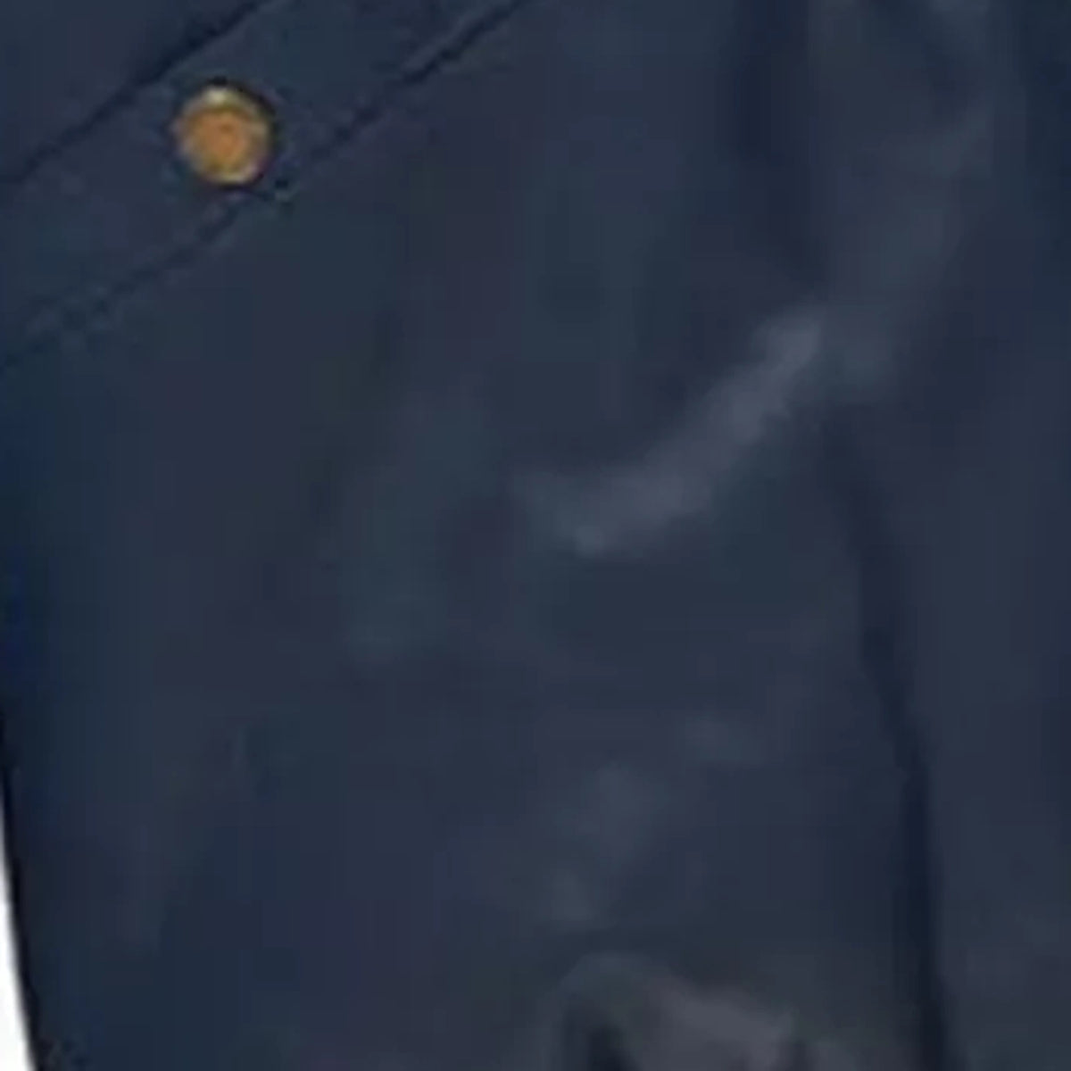 Close-up of leather texture of the MOTOGRIP red, white and navy lambskin leather puffer jacket, showing its navy body with red and white V panels.