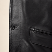Close-up of the leather texture and construction of the Loxley men's black leather trench coat.