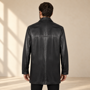 Rear view worn by a male model of the Loxley men's black leather trench coat.