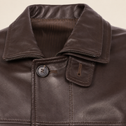 Close-up of the collar and fastening of the Loxley men's brown leather trench coat.
