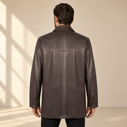Rear view worn by a male model of the Loxley men's brown leather trench coat.