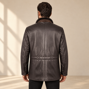 Rear view worn by a male model of the Merriton men's brown leather coat.