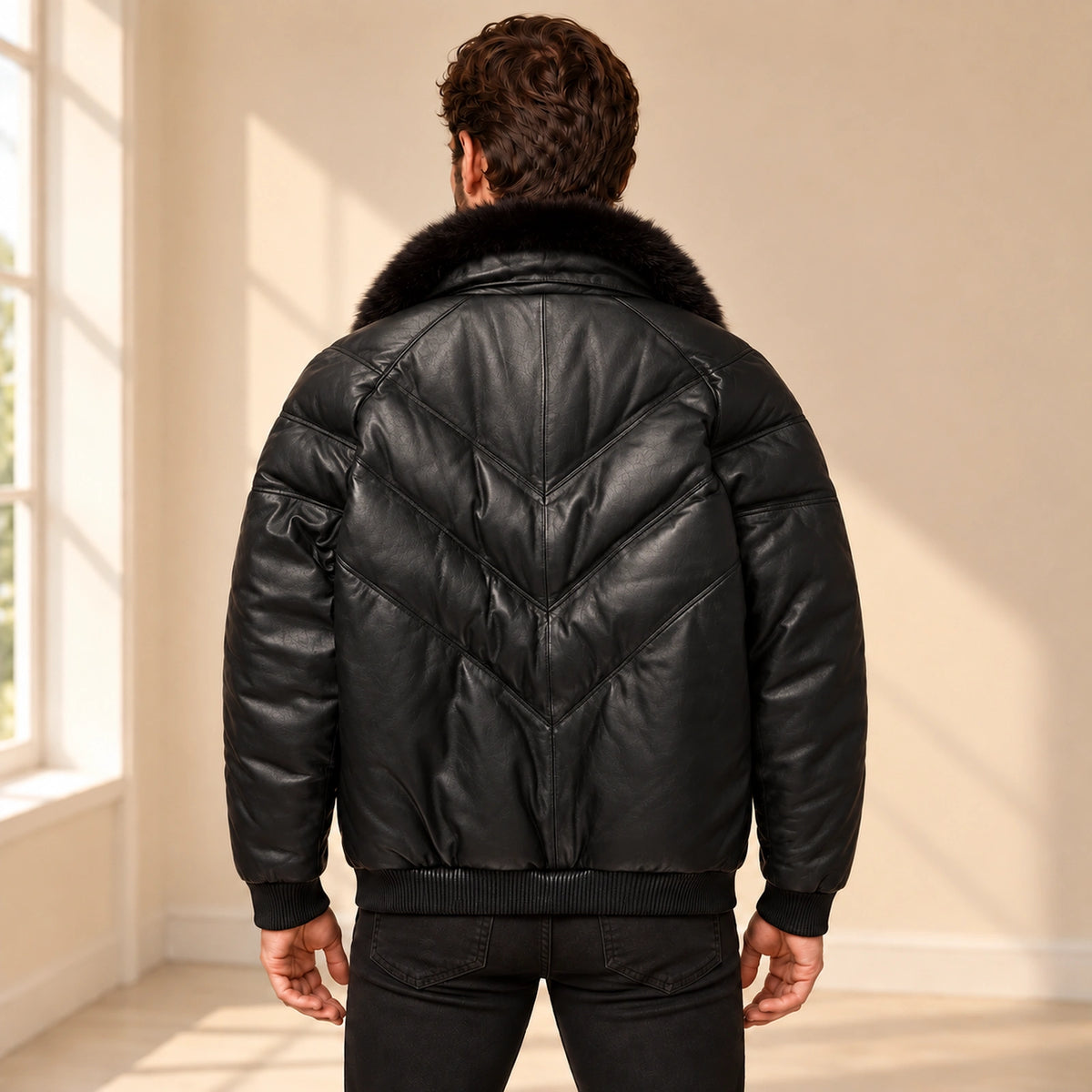 Back model view of the MOTOGRIP black lambskin leather puffer jacket, showing its black body with tonal V stitching.