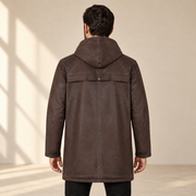 Rear view worn by a male model of the Norcliffe men's brown hooded leather parka.