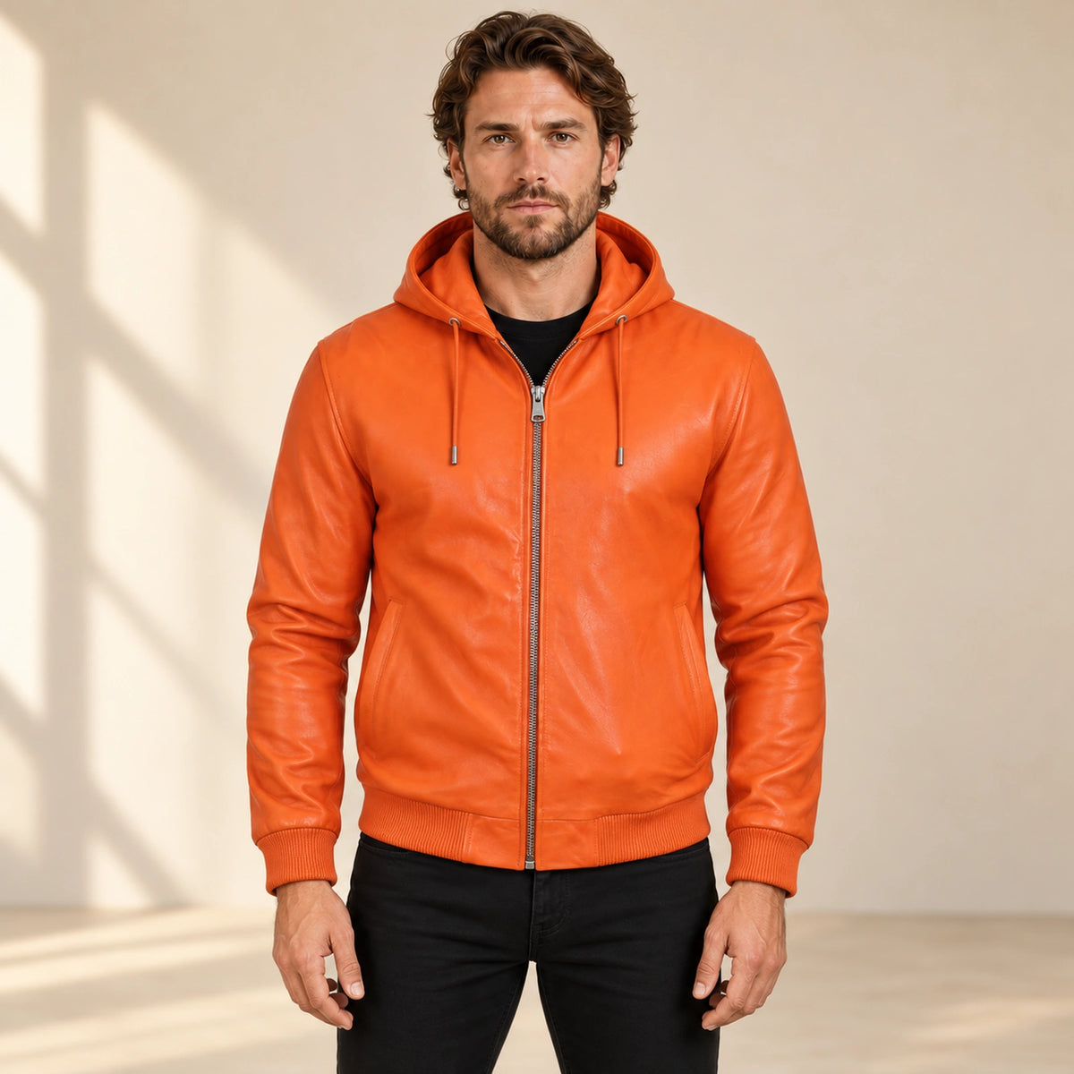 Male model wearing the Northwick Orange genuine leather zip hoodie, front view.